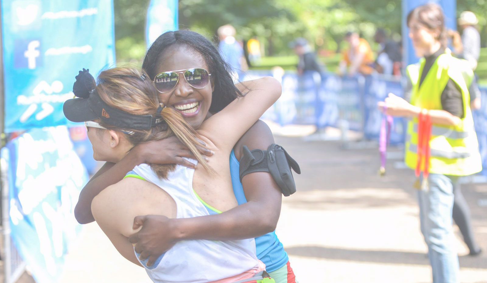 Two runners hugging at the finish line