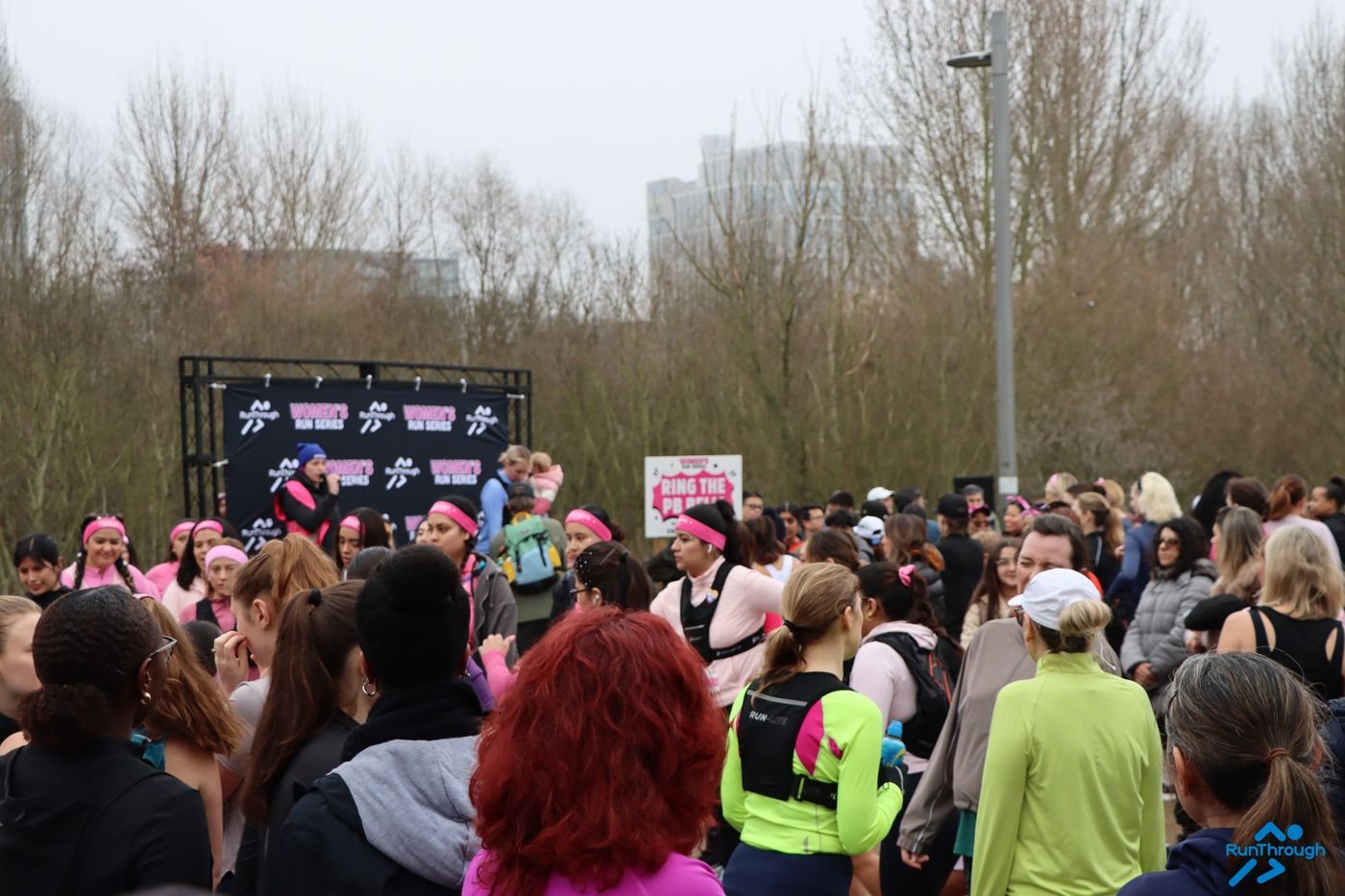 A run club group at the Women's Run Series backdrop, Queen Elizabeth Olympic Park